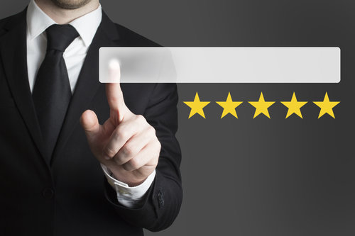 businessman pushing button five rating stars