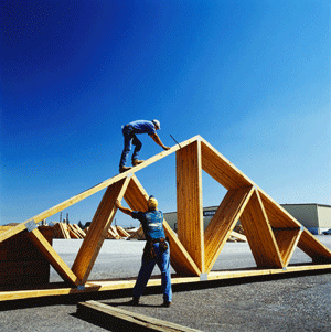 Workers with pre-assembled timber roof section