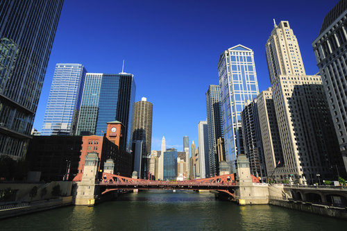 Chicago river in downtown with towering skyscrapers and a bridge
