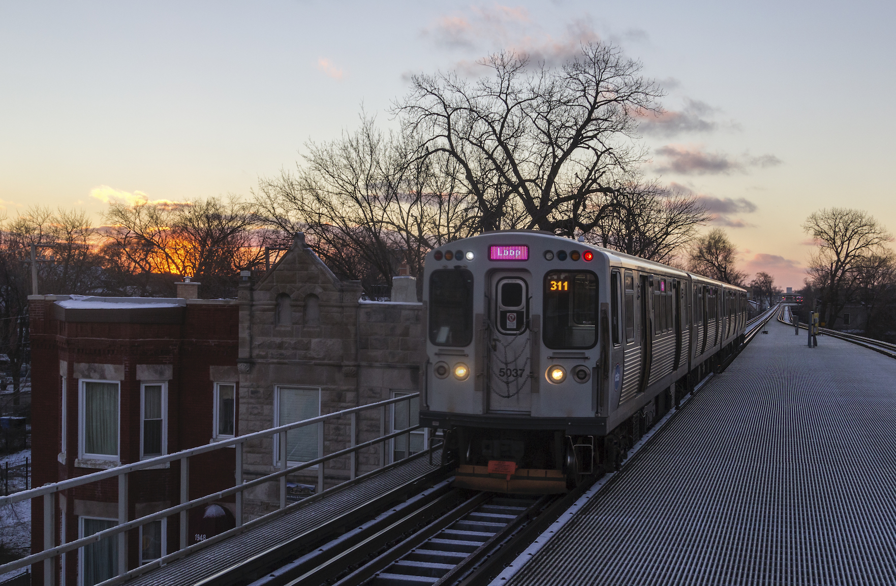 Loop-bound Pink Line pulling into the Kedzie station in Chicago's North Lawndale neighborhood.