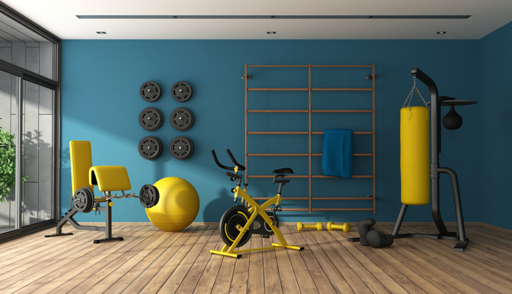 Blue home gym with black and yellow fitness equipment - Chicago Agent